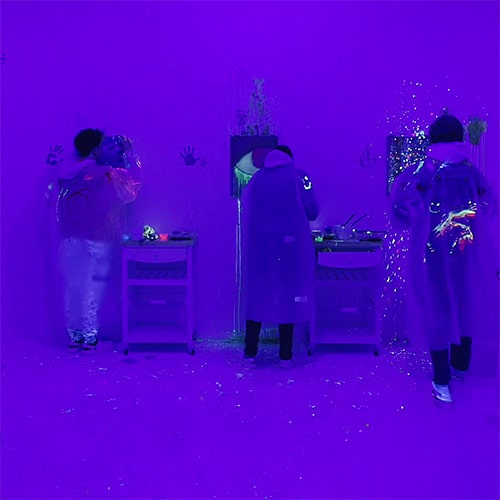 A group painting in UV light at Splash lab